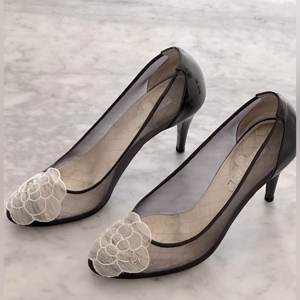 Black Chanel mesh heels with camelia flower detail.
